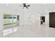 Open living space with marble floors, kitchen island, and sliding glass doors to backyard at 1105 Conant Ave, Safety Harbor, FL 34695