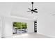 Main bedroom with high ceilings, sliding glass doors, and barn door at 1105 Conant Ave, Safety Harbor, FL 34695