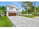 Modern two-story home with a gray paver driveway at 1105 Conant Ave, Safety Harbor, FL 34695