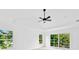 Bright bedroom with high ceilings, ceiling fan, and sliding glass doors at 1105 Conant Ave, Safety Harbor, FL 34695