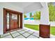 Covered front porch with a dark brown door at 1105 Conant Ave, Safety Harbor, FL 34695
