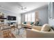 Bright living room featuring a comfy sofa, flat-screen TV and wood floors at 501 Knights Run Ave # 2120, Tampa, FL 33602