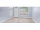 Spacious living room with light walls and tile floors, and a view to the front door at 1839 Sunrise Dunes Ct, Tarpon Springs, FL 34689