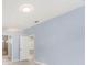 Light blue bedroom with wood-look floors and an ensuite bathroom at 1839 Sunrise Dunes Ct, Tarpon Springs, FL 34689