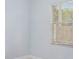 Bedroom with light blue walls, window with blinds, and wood-look floors at 1839 Sunrise Dunes Ct, Tarpon Springs, FL 34689