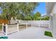 Private patio with white fence and lush green landscaping at 1839 Sunrise Dunes Ct, Tarpon Springs, FL 34689