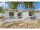 Landscaped backyard with a white fence and patio at 1839 Sunrise Dunes Ct, Tarpon Springs, FL 34689