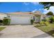 Front view of one-story house with attached garage at 1839 Sunrise Dunes Ct, Tarpon Springs, FL 34689