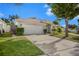Front view of one-story house with attached garage at 1839 Sunrise Dunes Ct, Tarpon Springs, FL 34689