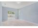 Bedroom with sliding doors to backyard and window with blinds at 1839 Sunrise Dunes Ct, Tarpon Springs, FL 34689