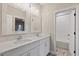 Bathroom with double vanity, quartz countertop and white cabinets at 13029 Paddock Wood Pl, Riverview, FL 33579