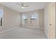 Spacious bedroom with carpeted floor, ceiling fan and large windows at 13029 Paddock Wood Pl, Riverview, FL 33579