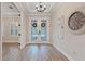 Spacious entryway with hardwood floors and statement clock at 13029 Paddock Wood Pl, Riverview, FL 33579
