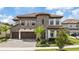Two-story home with stone accents and a three-car garage at 13029 Paddock Wood Pl, Riverview, FL 33579