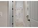Long hallway with herringbone patterned floors, leading to bathroom and closet at 13029 Paddock Wood Pl, Riverview, FL 33579