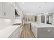 Modern kitchen featuring white cabinets, herringbone backsplash, and large island at 13029 Paddock Wood Pl, Riverview, FL 33579