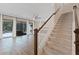 Elegant staircase with wooden railing leading to upper level at 13029 Paddock Wood Pl, Riverview, FL 33579