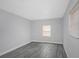 Grey bedroom with window and wood-look flooring at 6685 17Th N St, St Petersburg, FL 33702