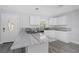 Modern kitchen with white cabinets and stunning marble countertops at 6685 17Th N St, St Petersburg, FL 33702