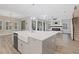 Open concept kitchen with large island, modern appliances, and Gathering room view at 13029 Paddock Wood Pl, Riverview, FL 33579