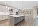 Modern kitchen with white cabinets, gray island, and stainless steel appliances at 13029 Paddock Wood Pl, Riverview, FL 33579