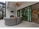 Relaxing patio with wicker furniture and an electric fireplace at 13029 Paddock Wood Pl, Riverview, FL 33579