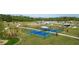 Aerial view of community amenities including playground, pickleball courts, and a lake at 13029 Paddock Wood Pl, Riverview, FL 33579
