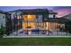 Beautiful backyard with pool and covered patio area at dusk at 13029 Paddock Wood Pl, Riverview, FL 33579
