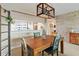 Bright dining room with wood table, unique light fixture, and accent wall at 6551 Shoreline Dr # 6202, St Petersburg, FL 33708