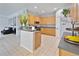 Kitchen with light wood cabinets, stainless steel appliances, and island at 2348 Silvermoss Dr, Wesley Chapel, FL 33544