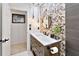 Bathroom with unique pebble tile feature wall and modern vanity at 2348 Silvermoss Dr, Wesley Chapel, FL 33544