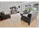 Living room with fireplace, leather furniture, and large TV at 2348 Silvermoss Dr, Wesley Chapel, FL 33544
