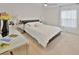 Spacious bedroom with a large bed, nightstands, and ample natural light at 2348 Silvermoss Dr, Wesley Chapel, FL 33544