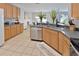 Kitchen with ample counter space, light wood cabinets, and stainless steel appliances at 2348 Silvermoss Dr, Wesley Chapel, FL 33544