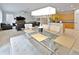 Open concept dining room with modern glass table and bench seating at 2348 Silvermoss Dr, Wesley Chapel, FL 33544