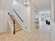 Bright entryway with tile flooring, staircase, and view of living room at 2348 Silvermoss Dr, Wesley Chapel, FL 33544