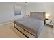 Spacious bedroom with plush carpeting and gray upholstered bed at 2348 Silvermoss Dr, Wesley Chapel, FL 33544