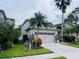 Two-story house with a two-car garage and landscaped front yard at 2348 Silvermoss Dr, Wesley Chapel, FL 33544