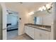 Double vanity bathroom with granite countertop and a view of a bedroom at 13012 Rain Lily Dr, Riverview, FL 33579