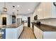 Modern kitchen with white cabinets, granite countertops and stainless steel appliances at 13012 Rain Lily Dr, Riverview, FL 33579