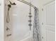 Bathroom with shower/tub combo and white tile surround at 13012 Rain Lily Dr, Riverview, FL 33579