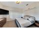 Spacious bedroom with large bed and modern TV at 13012 Rain Lily Dr, Riverview, FL 33579