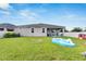 Fenced backyard, patio with grill, and inflatable pool at 13012 Rain Lily Dr, Riverview, FL 33579