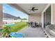 Covered patio with seating area, grill, and backyard view at 13012 Rain Lily Dr, Riverview, FL 33579