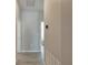 Clean and bright hallway with light gray walls and wood-look tile flooring at 13012 Rain Lily Dr, Riverview, FL 33579