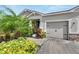 Single story home with two car garage and lush landscaping at 13012 Rain Lily Dr, Riverview, FL 33579