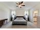 Bright bedroom featuring a ceiling fan and en-suite bathroom access at 13012 Rain Lily Dr, Riverview, FL 33579
