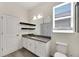 Bathroom with granite countertop, white cabinets, and gray floor tile at 13012 Rain Lily Dr, Riverview, FL 33579