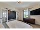 Main bedroom with double french doors and modern dresser at 13012 Rain Lily Dr, Riverview, FL 33579