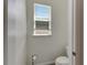 Small powder room with toilet and single window at 13012 Rain Lily Dr, Riverview, FL 33579